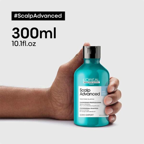 hand holding 300ml bottle of L'Oréal Scalp Advanced Anti-Dandruff Dermo-Clarifier Shampoo with Piroctine Olamine and Salicylic Acid, designed to soothe and clarify the scalp